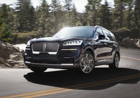 A Lincoln Aviator® SUV is being driven on a winding mountain road | Cavalier Lincoln in Chesapeake VA