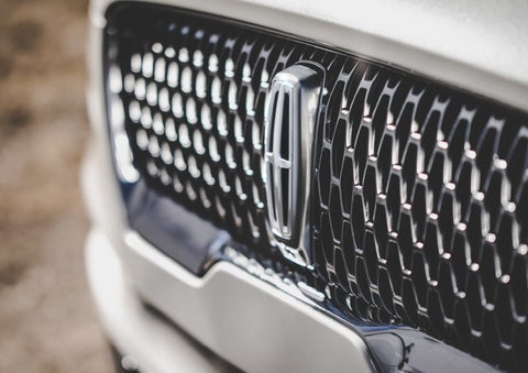 The grille of the 2024 Lincoln Aviator® Reserve model with an eye-catching repeated field of Lincoln Star logo shapes | Cavalier Lincoln in Chesapeake VA